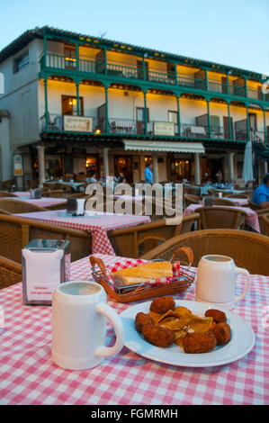 Spanish tapa: croquettes serving and two jugs of lager in a terrace. Main Square, Chinchon, Madrid province, Spain. Stock Photo