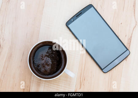 coffee and smartphone on a wooden background Stock Photo