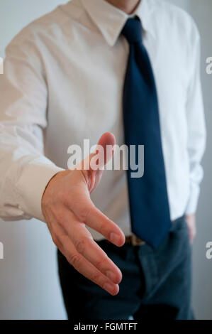 Man extending his open hand, offering handshake. Stock Photo