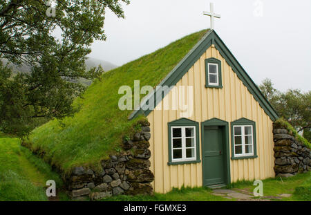 Iceland Hofskirkja yellow church turf grass in town of Hof in South Iceland 1884 the last turf church in Iceland Stock Photo