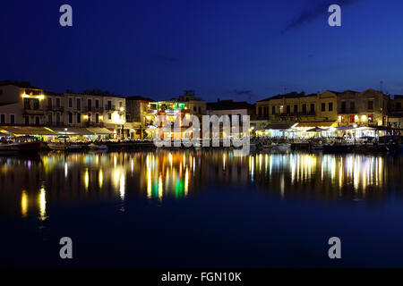 Restaurants abound and specializing in seafood in this beautiful Venetian Harbour on the island of Crete. Stock Photo