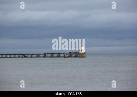 The lighthouse on the pier at Blyth in Northumberland, England. The pier juts into the North Sea. Stock Photo