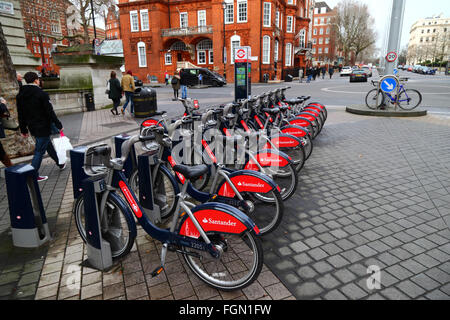 Santander Cycles hire bicycles at a docking station in Exhibition Road, Kensington, London, England Stock Photo