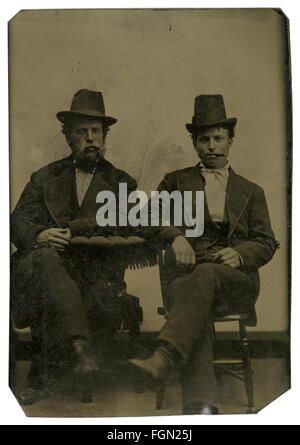 Circa 1860 tintype photograph, two gentlemen, possibly father and son, with cigars. SOURCE: ORIGINAL TINTYPE IMAGE. Stock Photo