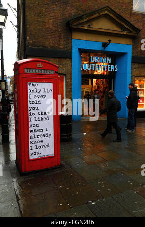 Quotation on old red telephone box, Seven Dials, near Covent Garden, London, England Stock Photo