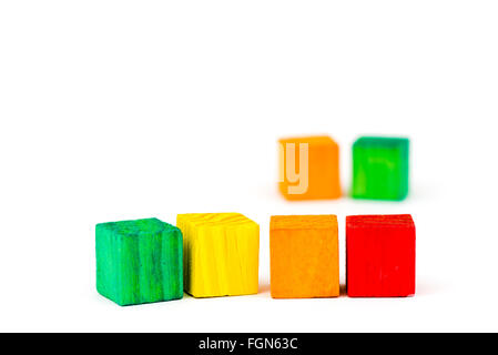 Six toy wooden colored blocks isolated on white background Stock Photo