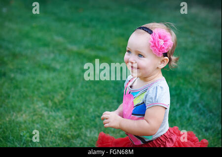 little happy cheerful girl running around playing and having fun Stock Photo