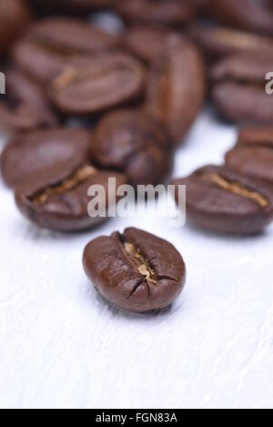 Closeup of coffee grains on wooden board Stock Photo