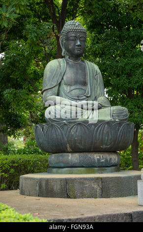 Tokyo Japan quiet area with Buddha statue at Sensoji Temple at Tokyo's oldest temple with green hedges and peaceful scene Stock Photo