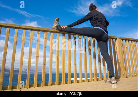 low angle view blue sky training injury prevention preventing "warming up" exercise exercising runner flexible flexibility Stock Photo