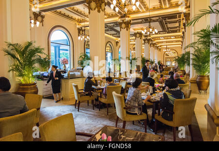 Hong Kong China  Peninsula Hotel high tea in lobby of exclusive hotel busy expensive Stock Photo