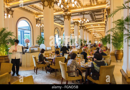 Hong Kong China  Peninsula Hotel high tea in lobby of exclusive hotel busy expensive Stock Photo