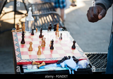 A man ready to make a move on a chess board Stock Photo
