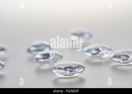 Clear transparent diamond beads on a white plastic table Stock Photo