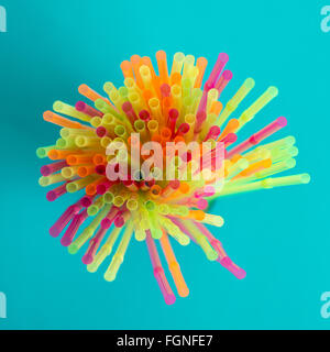 Colorful straws on blue background Stock Photo