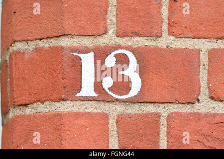 House number 13 sign painted on wall Stock Photo