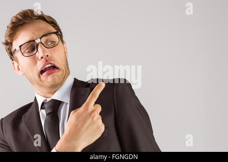 Young geeky businessman pointing to shoulder Stock Photo