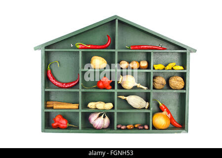 Green painted wooden shelf with a roof filled with various vegetable, nuts and spices isolated on white Stock Photo