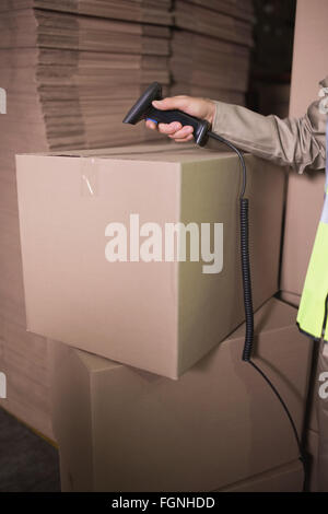 Worker using scanner in warehouse Stock Photo