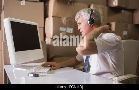 Warehouse manager using computer Stock Photo