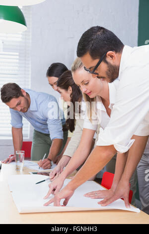 Team of architects going over blueprints Stock Photo