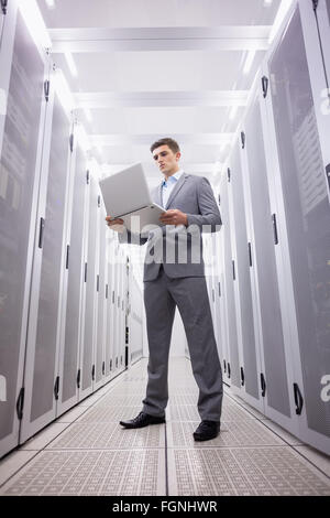 Concentrated technician in suit standing Stock Photo