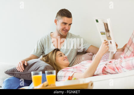 Cute couple relaxing on couch at breakfast Stock Photo