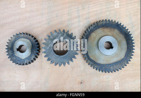 Huge set of rusty metal gears on wood background. Stock Photo