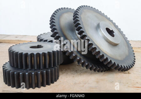 Huge set of rusty metal gears on wood box. Stock Photo