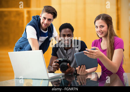 Composite image of creative young business team looking at digital tablet Stock Photo