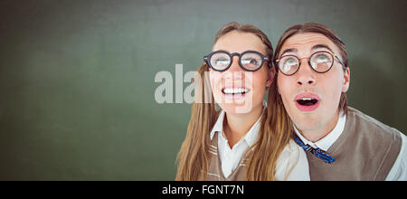 Composite image of geeky hipster couple raising eyes Stock Photo