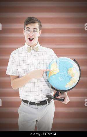 Composite image of geeky hipster holding a globe smiling at camera Stock Photo