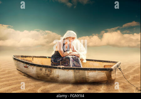 young beautiful exotic woman sitting in the boat on beach Stock Photo