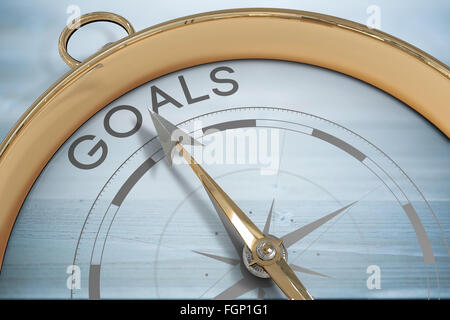 Composite image of compass pointing to goals Stock Photo