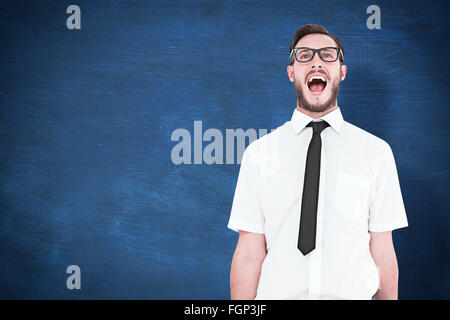 Composite image of geeky young businessman shouting loudly Stock Photo