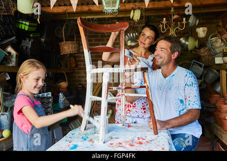 Family painting chair in workshop Stock Photo