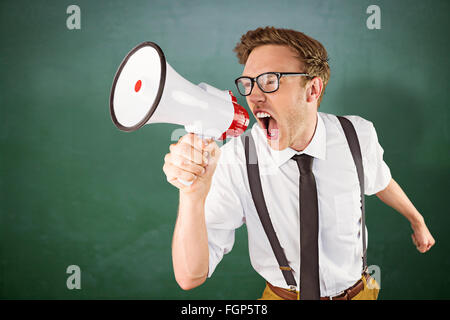 Composite image of geeky businessman shouting through megaphone Stock Photo