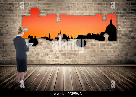 Composite image of businesswoman holding new tablet Stock Photo