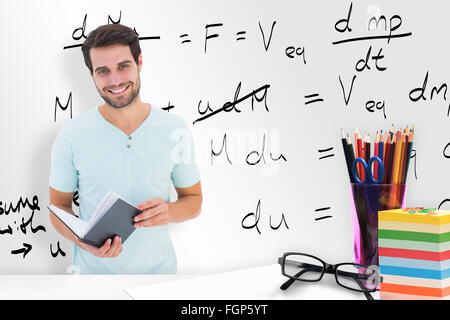 Composite image of student holding book Stock Photo