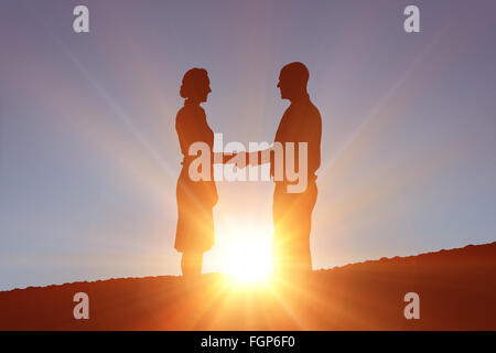 Composite image of silhouettes shaking hands Stock Photo