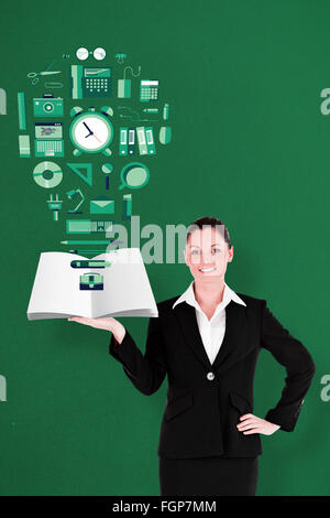 Composite image of businesswoman showing a book Stock Photo