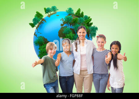 Composite image of cute pupils and teacher smiling at camera in computer class Stock Photo