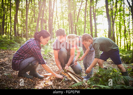 Family building campfire in forest Stock Photo