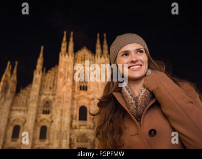 It is time to dress up and take a night tour in ultra-luxurious fashion expert - Milan, Italy. Portrait of smiling young woman i Stock Photo