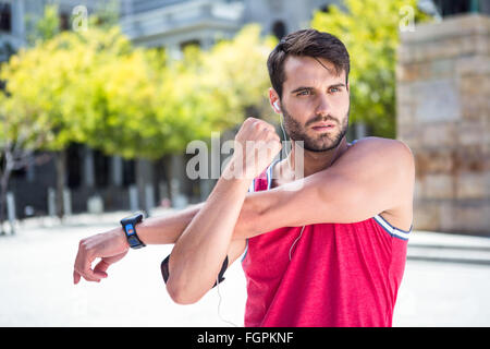 Handsome athlete doing arms stretching Stock Photo