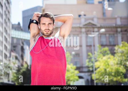 Handsome athlete doing arms stretching Stock Photo