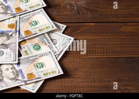 new 100 US dollars bills on wooden background Stock Photo