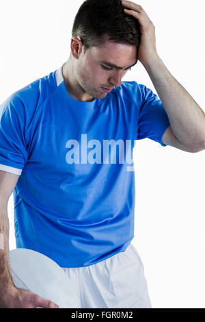 Disappointed rugby player holding his head Stock Photo