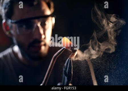 Close up of blacksmith shaping iron with blowtorch Stock Photo