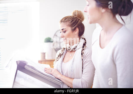 Interior designers browsing fabric swatches in office Stock Photo